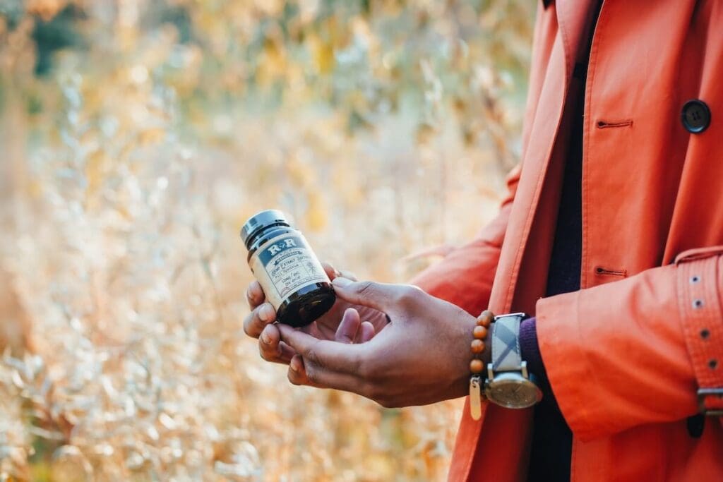 A registered dietitian nutritionist holding a probiotic blend of clinically studied probiotic strains which include lactobacillus casei, bifidobacterium lactis, and bifidobacterium strains