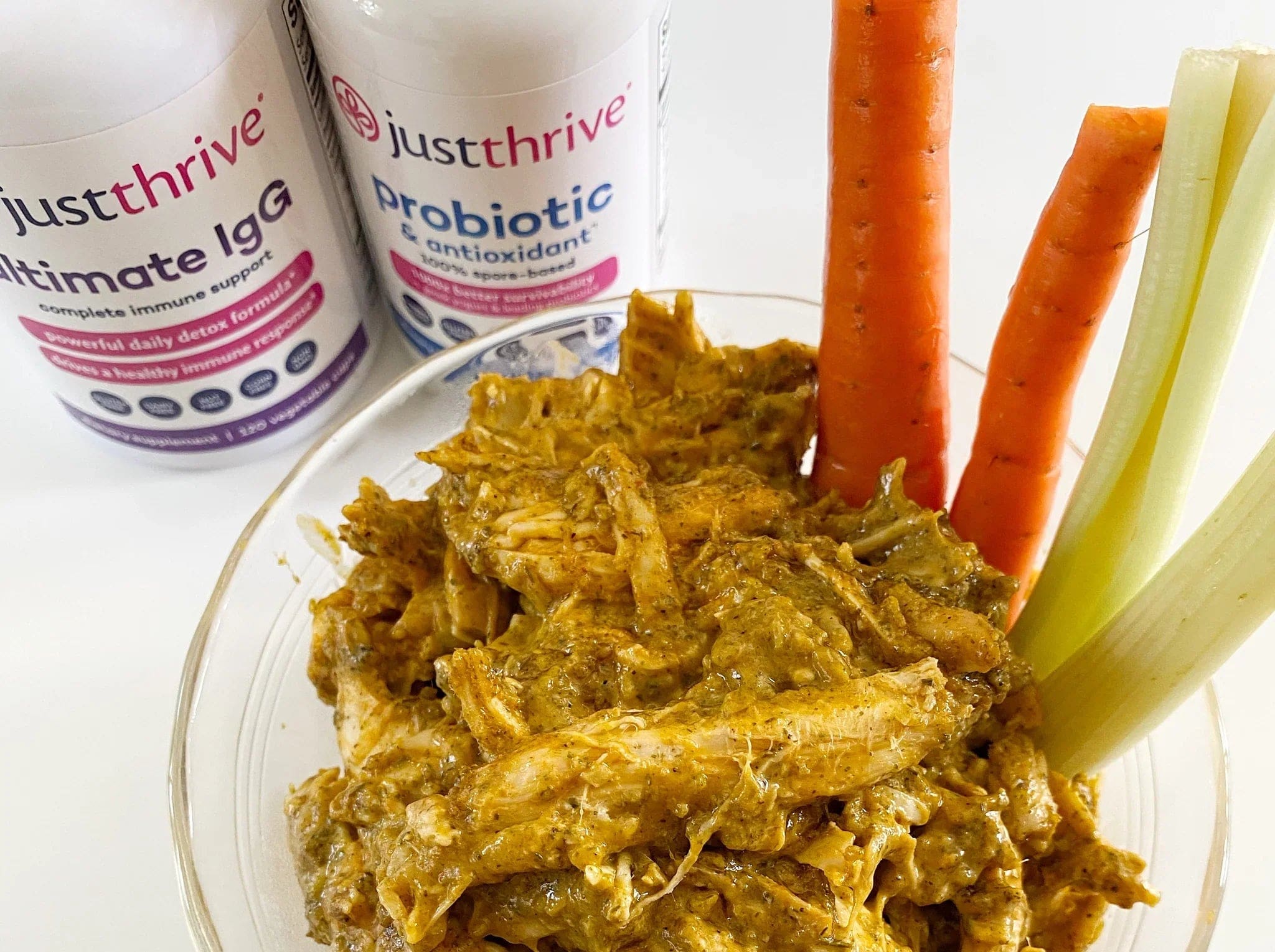 a plate of food with carrots and a couple white bottles