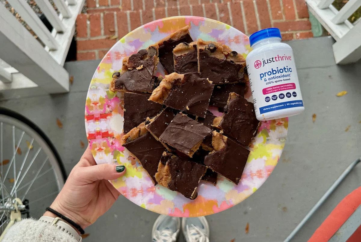 a plate of chocolate bars and a bottle of probiotics