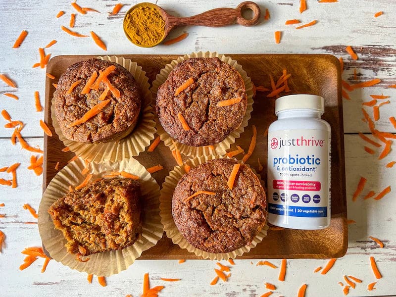 a tray of muffins and a bottle of probiotic