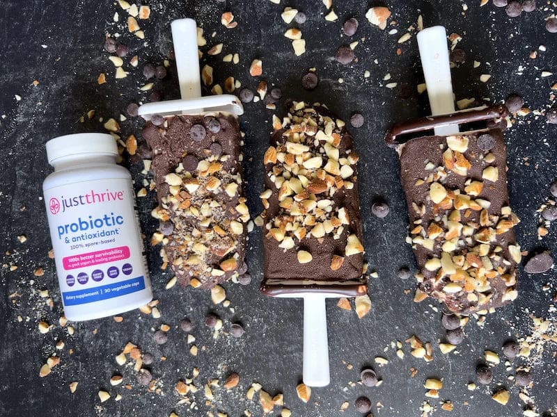 a group of chocolate popsicles with nuts on them