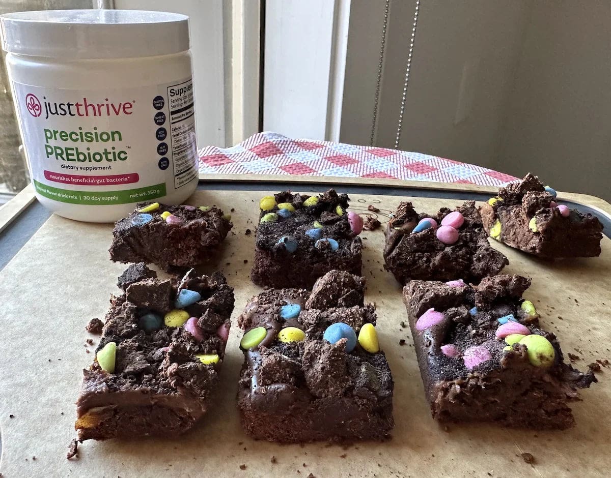 a brownie with candy on top and a jar of white powder